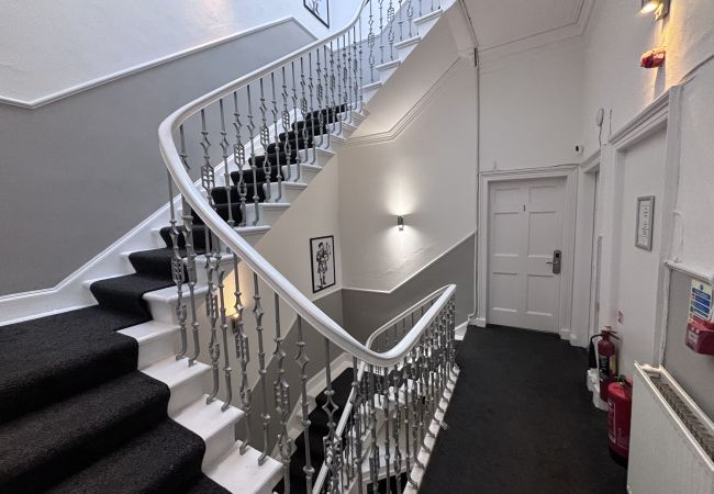 White spacious staircase leading to Haymarket Hostel Female Dorm