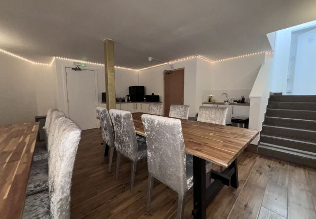 Spacious living room at Haymarket Hostel, Edinburgh, with seating and dining area