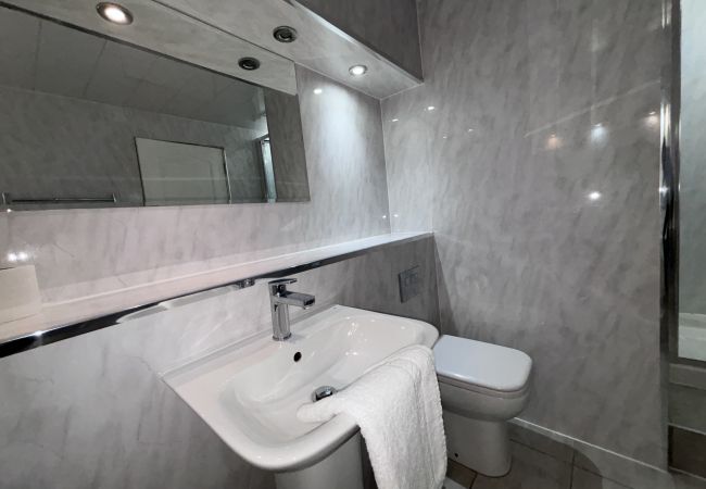 beautifully designed bathroom with sink, toilet and tiled floors