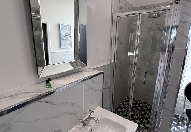 Full bathroom, beautifully tiled and shower