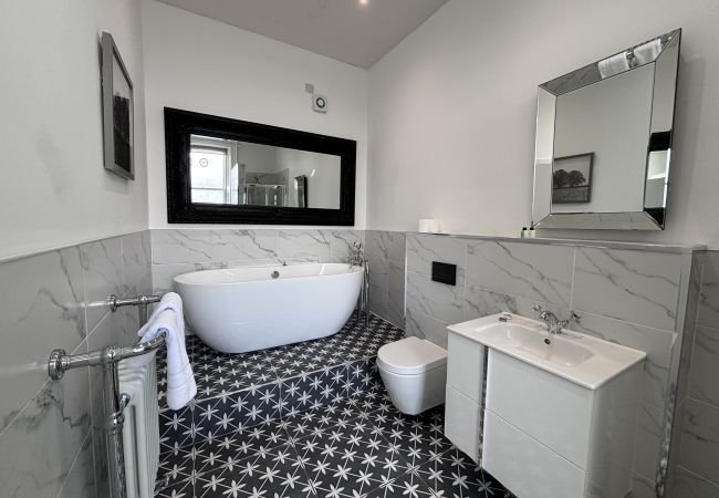 Spacious bathroom with bath tub and shower