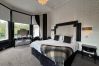 Richmond Park Hotel Junior Suite featuring a queen bed with stunning views of Richmond Park and the River Forth.